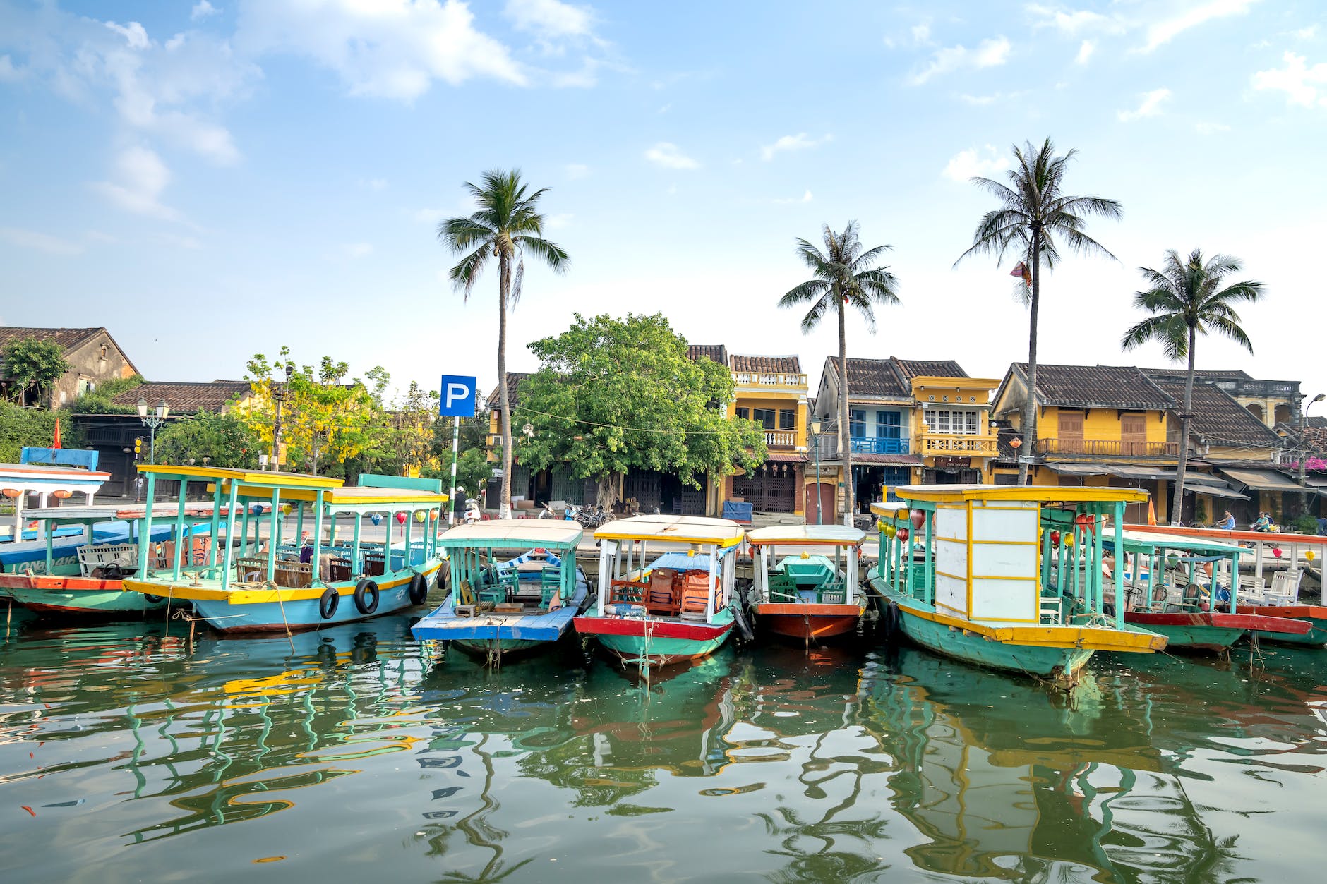 cruise boats moored on river in tropical village